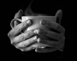 girl-holding-hot-cup-on-black-backgroundemotions-in-a-rainy-day