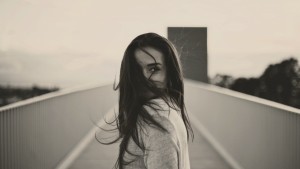 girl-with-long-hair-walking-on-the-bridge-enjoying-beautiful-sunset